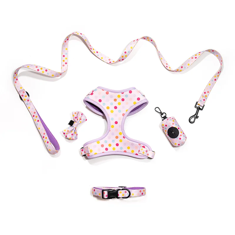 Matching dog harness, leash, collar, bow tie, and poop bag holder set in pink polka dot print, customizable for private label brands.